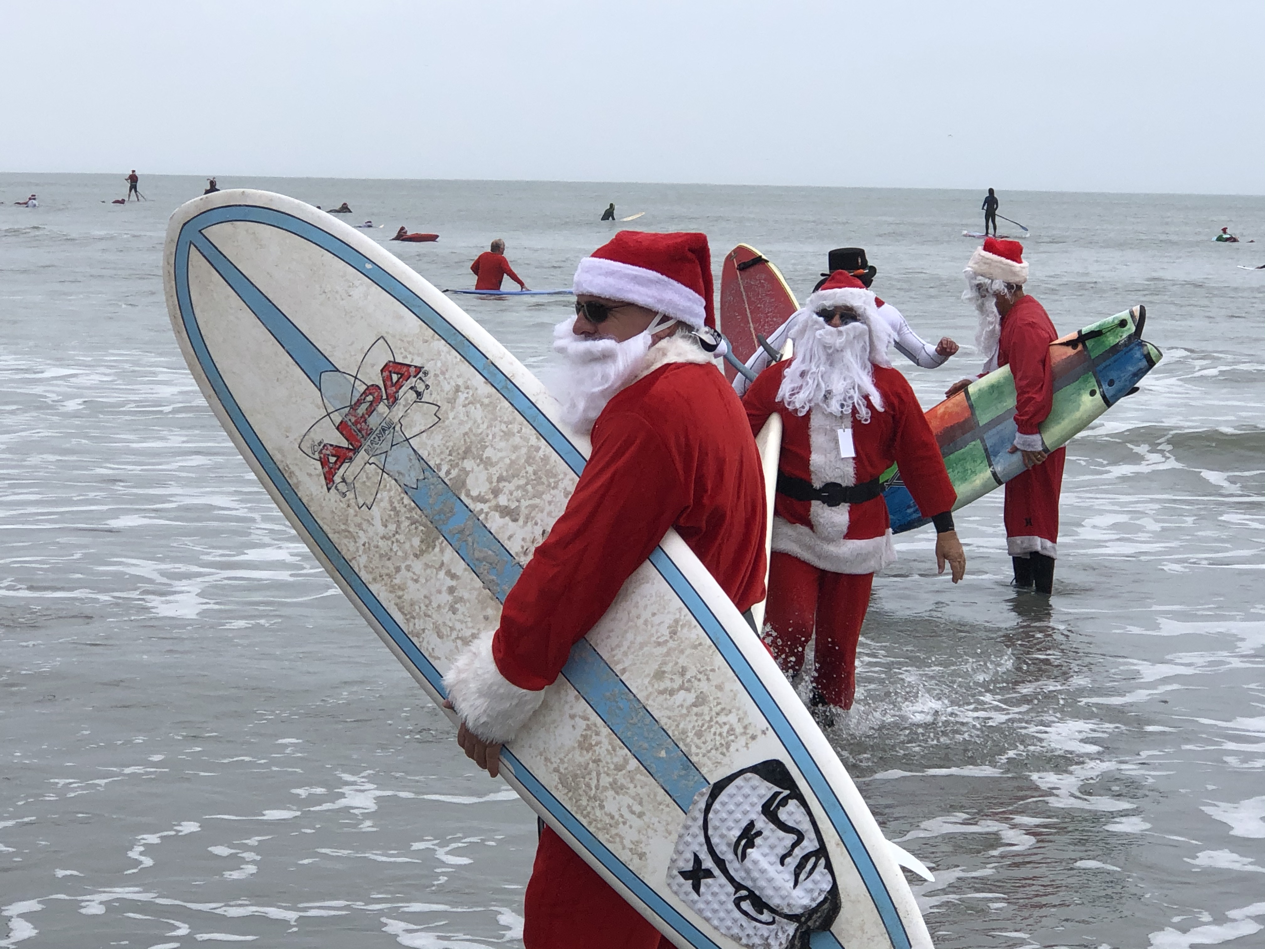 Surfing Santas Hit The Waves in Cocoa Beach, Florida Travel. Sip. Repeat.